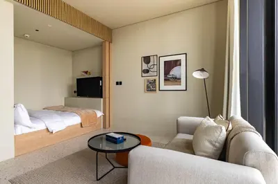 a bedroom with a bed and a couch and a table at Upside Living Business Bay Stunning Panoramic Burj Cityline Views by Simply Comfort in Dubai