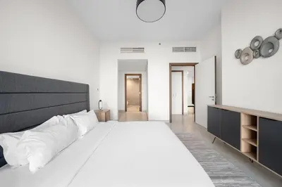 a large white bedroom with a large white bed at FIRST CLASS 2BR Panoramic Views of Dubai Frame in Dubai