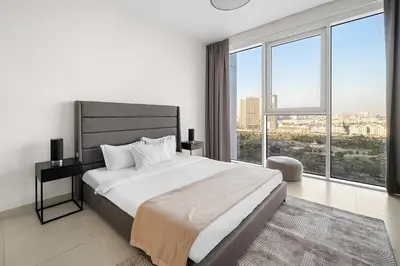 a bedroom with a large bed and large windows at FIRST CLASS 2BR Panoramic Views of Dubai Frame in Dubai