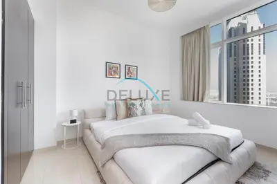 a white bedroom with a bed and a window at Spectacular 1BR in Botanica Tower 1 Dubai Marina by Deluxe Holidy Homes in Dubai