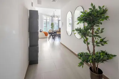a hallway with white walls and a potted plant at Frank Porter - Urban Oasis in Dubai
