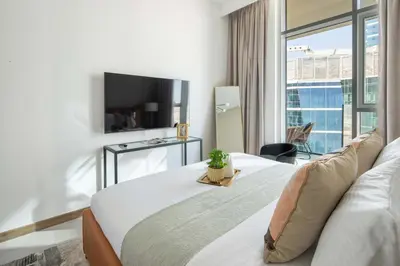 a hotel room with a bed and a large window at Frank Porter - Urban Oasis in Dubai
