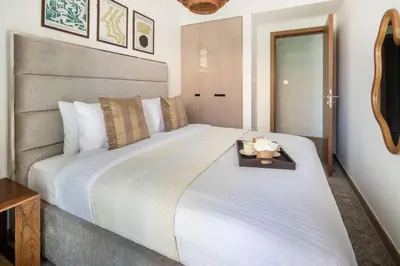a bedroom with a large white bed with a tray on it at Frank Porter - Urban Oasis in Dubai
