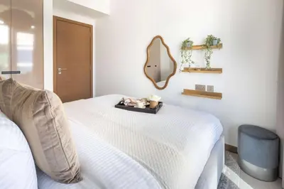 a bedroom with a bed with a mirror on the wall at Frank Porter - Urban Oasis in Dubai