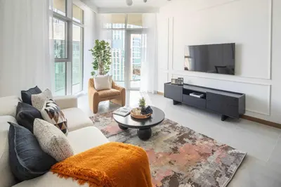 a living room with a couch and a tv at Frank Porter - Urban Oasis in Dubai
