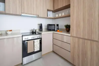 a kitchen with a stove and a microwave at Frank Porter - Urban Oasis in Dubai