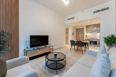 a living room with a couch and a tv at HAVN - 1 Bedroom in Azizi Park Avenue, Meydan in Dubai
