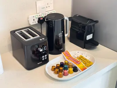 a counter with a coffee maker and a plate of food at Premium 3BR l Office with Burj Khalifa & Fountain Views in Dubai