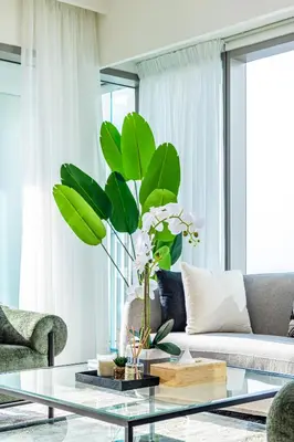 a living room with a couch and a glass table at Premium 3BR l Office with Burj Khalifa & Fountain Views in Dubai