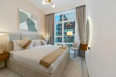 a bedroom with a large bed and a window at FAM Living - Urban Oasis 2bedroom, Business Bay in Dubai