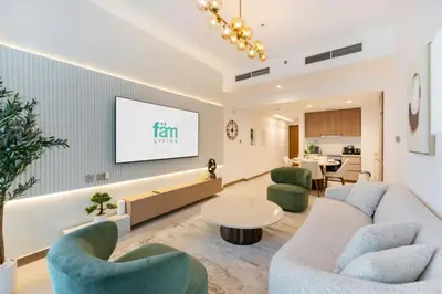 a living room with a couch and chairs and a tv at FAM Living - Urban Oasis 2bedroom, Business Bay in Dubai