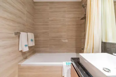 a bathroom with a tub and a sink and a shower at FAM Living - Urban Oasis 2bedroom, Business Bay in Dubai