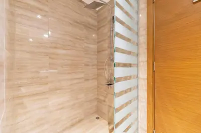 a shower with a glass door in a bathroom at FAM Living - Urban Oasis 2bedroom, Business Bay in Dubai