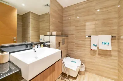 a bathroom with a white sink and a toilet at FAM Living - Urban Oasis 2bedroom, Business Bay in Dubai