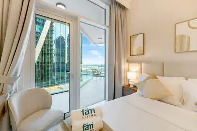a hotel room with a bed and a large window at FAM Living - Urban Oasis 2bedroom, Business Bay in Dubai