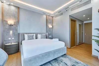 a bedroom with a large white bed in a room at bnbme - Luxury 4BR Downtown Views II Apt Burj Khalifa Views Pool Gym Parking in Dubai