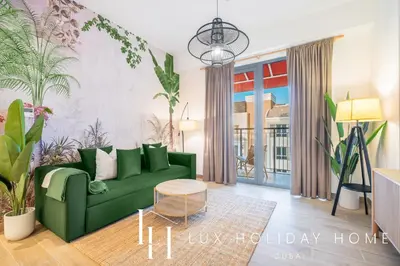 a living room with a green couch and plants at LUX The La Mer Infinity View- Luxury Boho Suite 2 in Dubai