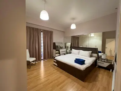 a bedroom with a bed with a blue bag on it at Luxurious JBR Beach Facing 4BHK in Dubai