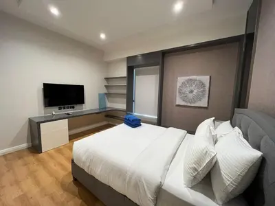 a bedroom with a large bed and a television at Luxurious JBR Beach Facing 4BHK in Dubai