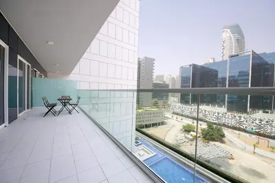 a balcony with a table and chairs on a building at Wecation Damac Vera - Business Bay in Dubai