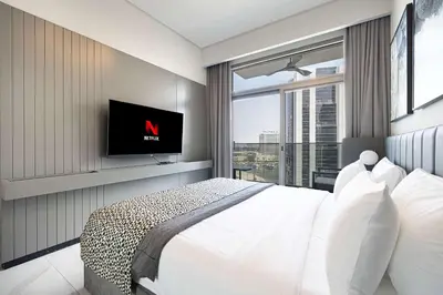 a bedroom with a large bed with a tv on the wall at MajeStay - MAG Living in Dubai