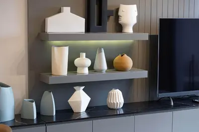 a display of vases and vases on shelves at MajeStay - MAG Living in Dubai