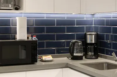 a kitchen counter with a sink and a microwave at MajeStay - MAG Living in Dubai