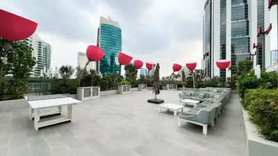 a patio with couches and tables in a city at MajeStay - MAG Living in Dubai