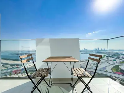 a table and two chairs on a balcony with a view at Luxury One Bedroom with Balcony & partial Burj Khalifa View in Dubai