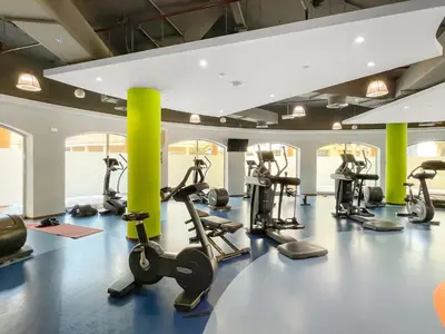 a gym with treadmills and elliptical machines at JBR Beach 2Bed Apartment with Full Marina View in Dubai