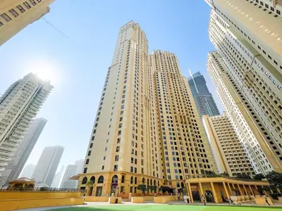 a large building in a city with tall buildings at JBR Beach 2Bed Apartment with Full Marina View in Dubai