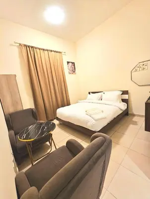 a bedroom with a bed and a chair and a couch at Room near to Lamer Beach Jumeirah one walk distance oima leasing property in Dubai