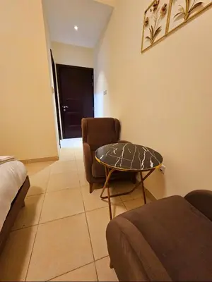 a room with a couch and a table and a chair at Room near to Lamer Beach Jumeirah one walk distance oima leasing property in Dubai