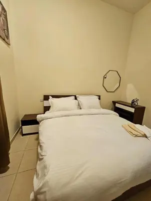 a bedroom with a large white bed with a mirror at Room near to Lamer Beach Jumeirah one walk distance oima leasing property in Dubai