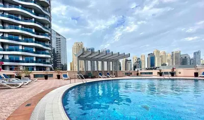 a large swimming pool with a city skyline in the background at Studio near beach and Metro in Dubai Marina Z1003 in Dubai
