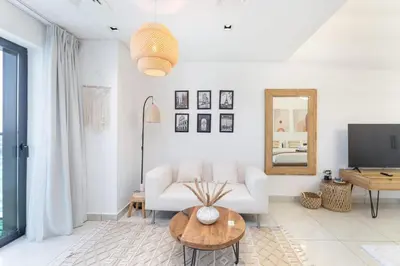 a living room with a white couch and a table at SuCasa in Dubai