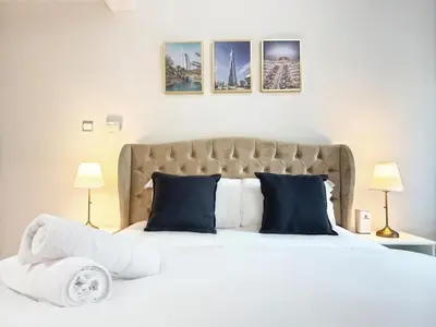 a bedroom with a large white bed with blue pillows at Studio in Dubai Marina near beach and Metro Z514 in Dubai