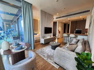 a living room with a couch and a table at SOLARTE Luxe - Marina Gate - Spectacular Pools with Marina Views in Dubai