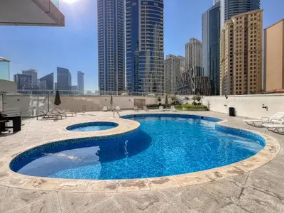 a swimming pool on top of a building with tall buildings at ShoresInn - Dubai Marina's Classic Stay in Dubai