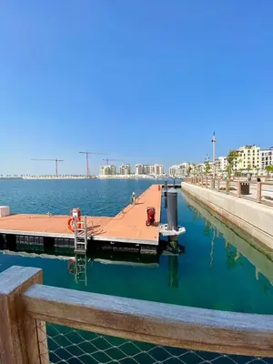 a dock in the middle of a body of water at La Mer Beach Jumeirah 1 bedroom hall Beach view balcony burj khalifa view walk distance few steps by oima leasing property in Dubai