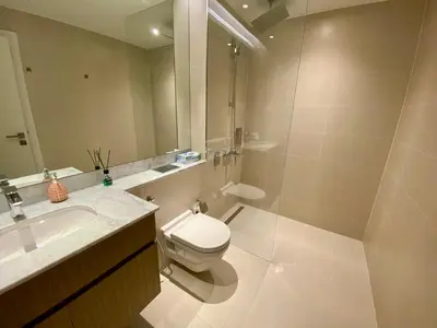 a bathroom with a toilet and a sink and a mirror at La Mer Beach Jumeirah 1 bedroom hall Beach view balcony burj khalifa view walk distance few steps by oima leasing property in Dubai