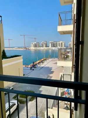 a balcony with a view of the ocean and buildings at La Mer Beach Jumeirah 1 bedroom hall Beach view balcony burj khalifa view walk distance few steps by oima leasing property in Dubai