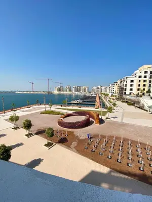 a view of a park with chairs and the water at La Mer Beach Jumeirah 1 bedroom hall Beach view balcony burj khalifa view walk distance few steps by oima leasing property in Dubai