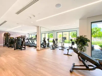 a gym with a bunch of treadmills and ellipticals at BURJ ROYALE - Full Burj Khalifa & Fountain Views - LUXE Apartment in Dubai