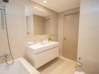 a white bathroom with a sink and a mirror at BURJ ROYALE - Full Burj Khalifa & Fountain Views - LUXE Apartment in Dubai