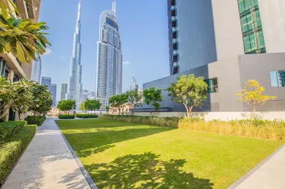 a park in the middle of a city with tall buildings at BURJ ROYALE - Full Burj Khalifa & Fountain Views - LUXE Apartment in Dubai