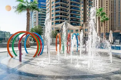 a fountain with colorful water fountains in a city at Best Location Marina & Sea View 1 min from JBR in Dubai