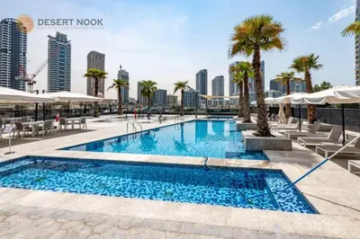 a swimming pool with palm trees and buildings at Best Location Marina & Sea View 1 min from JBR in Dubai