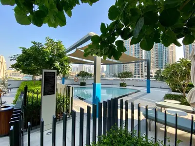 a fence around a swimming pool in a city at Grande signature residence Smart Burj khalifa Fountains view large 3 bedroom hall 4 bathroom view burj khalifa Fountains from hall and rooms balcony in Dubai