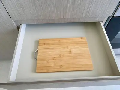 a cutting board in a drawer of a kitchen at Grande signature residence Smart Burj khalifa Fountains view large 3 bedroom hall 4 bathroom view burj khalifa Fountains from hall and rooms balcony in Dubai